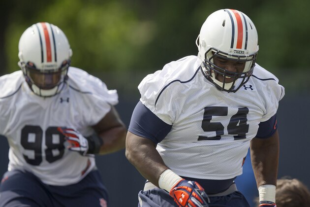 Auburn defensive lineman Angelo Blackson (98) left, and defensive lineman Jeffrey Whitaker (54) right, run drills during an NCAA college football practice, at the Auburn Sports Complex on Friday, Aug. 1, 2014, in Auburn, Ala. (AP Photo/Brynn Anderson)