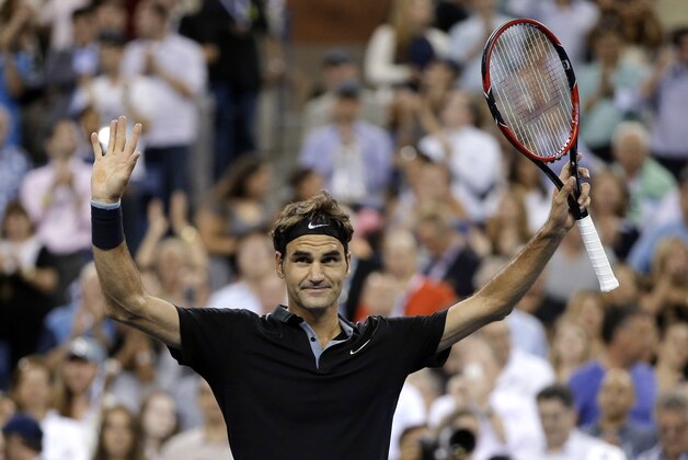 Roger Federer, of Switzerland, waves to the crowd after defeating Marinko Matosevic, of Australia, in the first round of the U.S. Open tennis tournament Tuesday, Aug. 26, 2014, in New York. Federer won 6-3, 6-4, 7-6 (4). (AP Photo/Darron Cummings)
