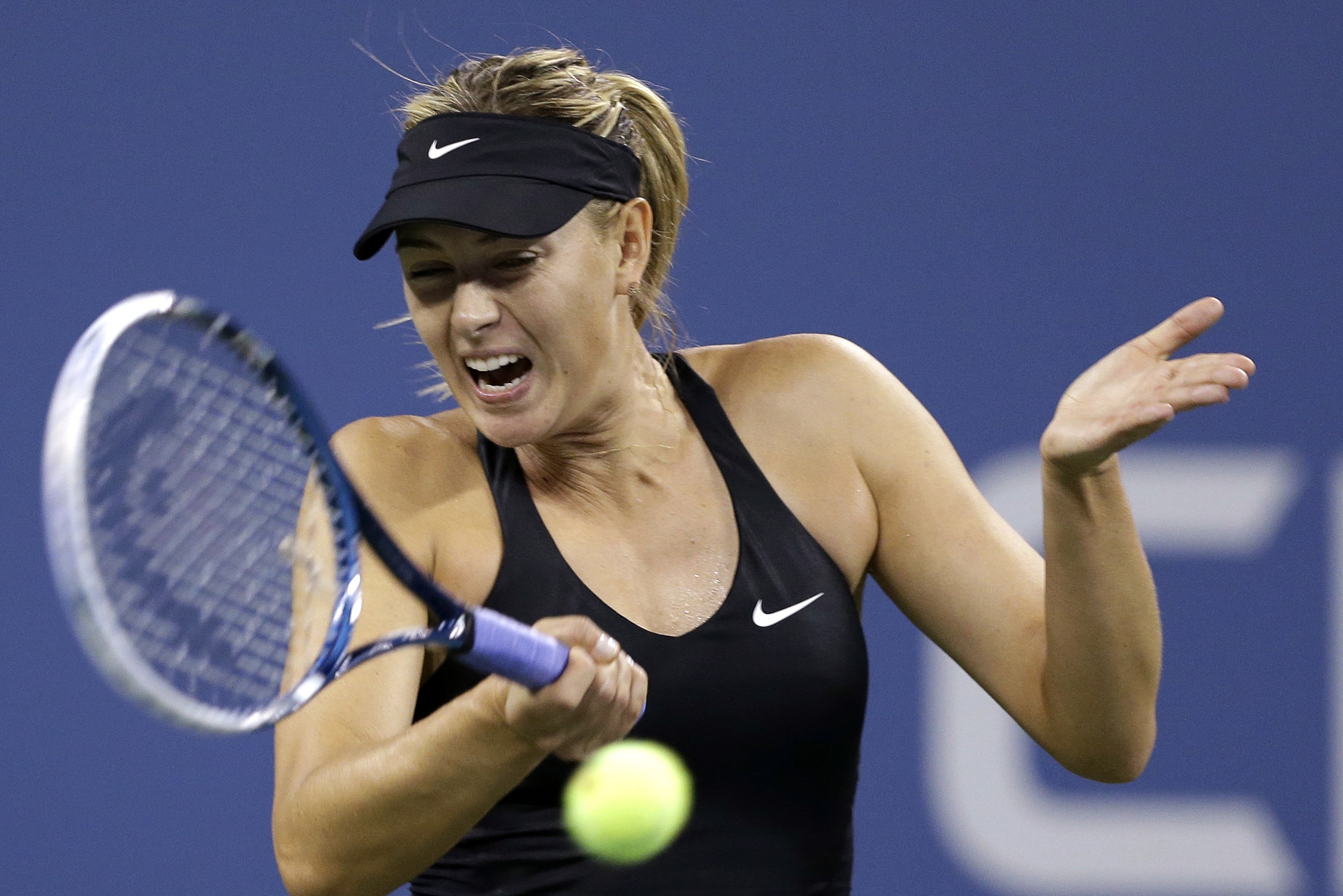 Maria Sharapova, of Russia, returns a shot to Maria Kirilenko, of Russia, during the opening round of the U.S. Open tennis tournament Monday, Aug. 25, 2014, in New York. (AP Photo/Darron Cummings)