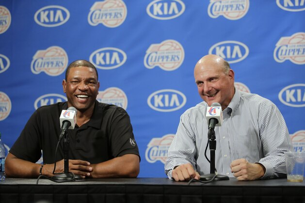 New Los Angeles Clippers owner Steve Ballmer, right, and head coach Doc Rivers share a laughter during a news conference held after the Clippers Fan Festival on Monday, Aug. 18, 2014, in LA. Ballmer paid a record $2 billion for the team in a sale that was confirmed by a judge last week. (AP Photo/Jae C. Hong)