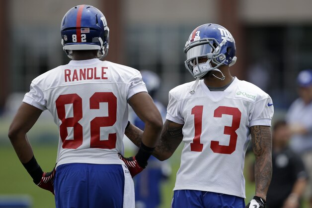New York Giants wide receiver Odell Beckham, right, talks with wide receiver Rueben Randle during a NFL football camp in East Rutherford, N.J., Thursday, July 24, 2014. (AP Photo/Seth Wenig)