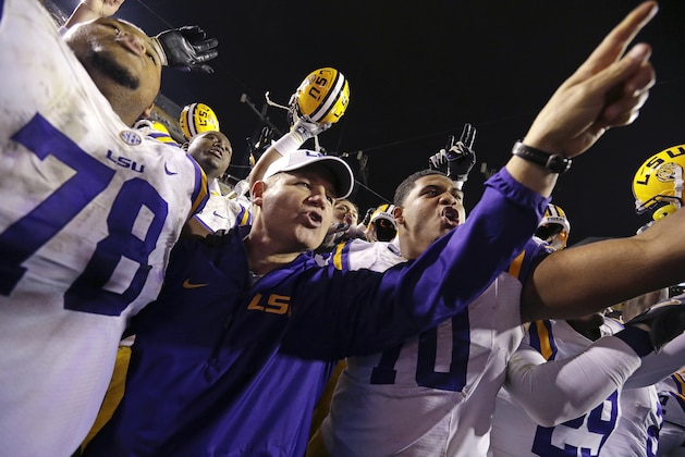LSU head coach Les Miles celebrates with players after their NCAA college football game against Texas A&M in Baton Rouge, La., Saturday, Nov. 23, 2013. LSU won 34-10. (AP Photo/Gerald Herbert)