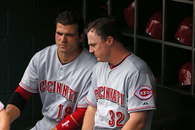 Cincinnati Reds' Joey Votto, left, and teammate Jay Bruce (32), sit on the bat rack before a baseball game against the Pittsburgh Pirates in Pittsburgh Thursday, June 19, 2014. The Pirates won 4-3 in 12 innings. (AP Photo/Gene J. Puskar)