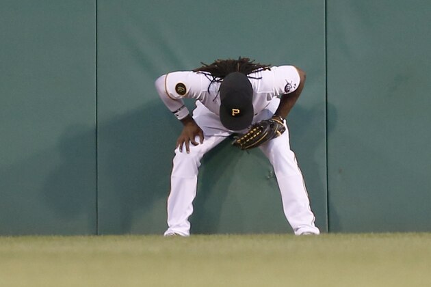 Pittsburgh Pirates center fielder Andrew McCutchen leans against the center field wall after making a catch on a fly ball by St. Louis Cardinals' Matt Carpenter in the third inning of the baseball game on Tuesday, Aug. 26, 2014, in Pittsburgh. McCutchen stayed in the game until the sixth inning.(AP Photo/Keith Srakocic)