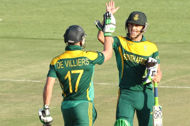 South African player Faf du Plessis, right, celebrates with AB de Villiers after scoring 100 runs during the   cricket One Day International match against Australia in  Harare Zimbabwe Wednesday, Aug. 27, 2014. The two teams are in Zimbabwe for a triangular  ODI series with Zimbabwe (AP Photo/Tsvangirayi Mukwazhi)