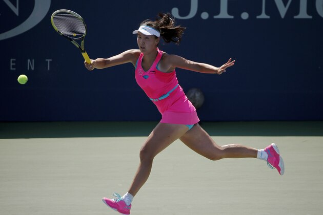 Shuai Peng, of China, returns a shot against Agnieszka Radwanska, of Poland, of Australia, during the second round of the 2014 U.S. Open tennis tournament, Wednesday, Aug. 27, 2014, in New York. (AP Photo/Elise Amendola)