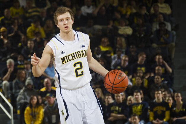 Michigan guard Spike Albrecht (2) dribbles the ball, in the first half of an NCAA college basketball game against Minnesota at Crisler Center in Ann Arbor, Mich., Saturday, March 1, 2014. (AP Photo/Tony Ding)