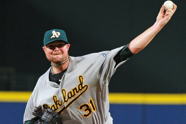 ATLANTA, GA - AUGUST 17: Jon Lester #31 of the Oakland Athletics throws a first inning pitch against the Atlanta Braves at Turner Field on August 17, 2014 in Atlanta, Georgia. (Photo by Scott Cunningham/Getty Images)