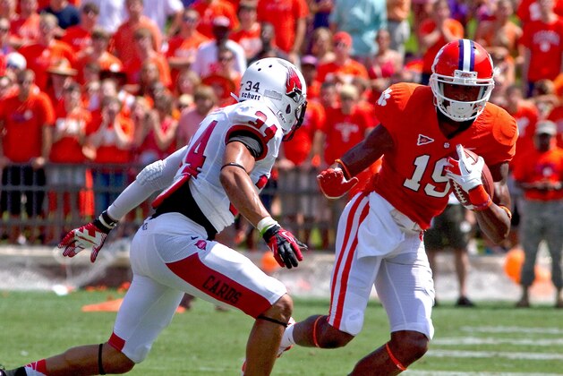 Sep 8, 2012; Clemson, SC, USA; Clemson Tigers wide receiver Charone Peake (19) carries the ball while being defended by Ball State Cardinals safety Jarrett Swaby (34) during the first quarter of the game at Memorial Stadium. Mandatory Credit: Joshua S. Kelly-USA TODAY Sports