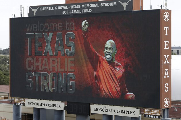 ADVANCE FOR WEEKEND EDITIONS, AUG. 15-17 - FILE - In this Jan. 6, 2014 file photo, a welcome sign is displayed on the scoreboard at Darrell K Royal–Texas Memorial Stadium for new Texas NCAA college football coach Charlie Strong in Austin, Texas. (AP Photo/Eric Gay, File)