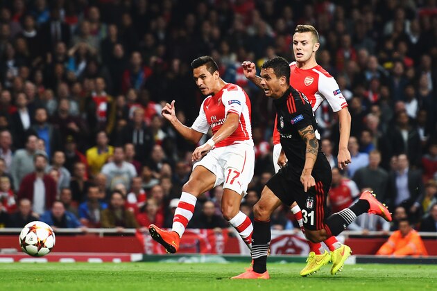 LONDON, ENGLAND - AUGUST 27:  Alexis Sanchez (left) of Arsenal shoots and scores past Tolga Zengin the Besiktas goalkeeper during the UEFA Champions League Qualifier 2nd leg match between Arsenal and Besiktas at the Emirates Stadium on August 27, 2014 in London, United Kingdom.  (Photo by Shaun Botterill/Getty Images)