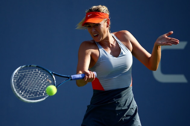 NEW YORK, NY - AUGUST 27:  Maria Sharapova of Russia returns a shot against Alexandra Dulgheru of Romania during their women's singles second round match on Day Three of the 2014 US Open at the USTA Billie Jean King National Tennis Center on August 27, 2014 in the Flushing neighborhood of the Queens borough of New York City.  (Photo by Streeter Lecka/Getty Images)