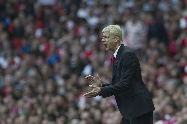 Arsenal's manager Arsene Wenger gives instructions from the sidelines during their English Premier League soccer match against Crystal Palace, at Emirates Stadium, in London, Saturday, Aug. 16, 2014. (AP Photo/Bogdan Maran)
