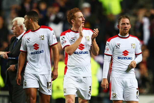 MILTON KEYNES, ENGLAND - AUGUST 26: Dean Lewington (C) of Milton Keynes Dons applauds the fans after his team's 4-0 victory during the Capital One Cup Second Round match between MK Dons and Manchester United at Stadium mk on August 26, 2014 in Milton Keynes, England.  (Photo by Clive Mason/Getty Images)