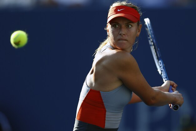 Maria Sharapova, of Russia, returns a shot against Alexandra Dulgheru, of Romania, during the second round of the 2014 U.S. Open tennis tournament, Wednesday, Aug. 27, 2014, in New York. (AP Photo/Matt Rourke)