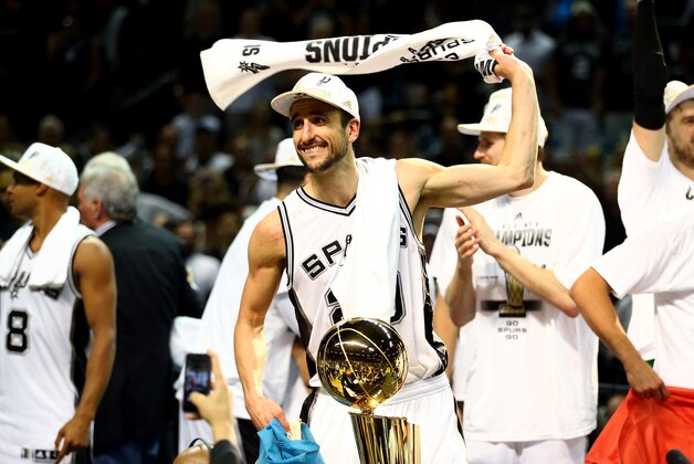 SAN ANTONIO, TX - JUNE 15: Manu Ginobili #20 of the San Antonio Spurs celebrates with the Larry O'Brien trophy after defeating the Miami Heat in Game Five of the 2014 NBA Finals at the AT&T Center on June 15, 2014 in San Antonio, Texas. NOTE TO USER: User expressly acknowledges and agrees that, by downloading and or using this photograph, User is consenting to the terms and conditions of the Getty Images License Agreement.  (Photo by Andy Lyons/Getty Images)