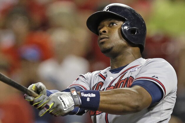 Atlanta Braves' Justin Upton hits a two-run home run off Cincinnati Reds relief pitcher Manny Parra in the 12th inning of a baseball game, Friday, Aug. 22, 2014, in Cincinnati. Atlanta won 3-1 in 12 inninngs. (AP Photo/Al Behrman)