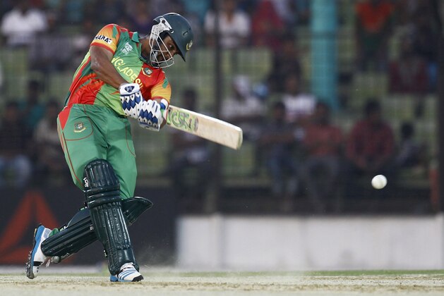 Bangladeshi cricketer Tamim Iqbal plays a shot during a warm-up cricket match against United Arab Emirates ahead of the Twenty20 World Cup Cricket in Fatullah, near Dhaka, Bangladesh, Wednesday, March 12, 2014. (AP Photo/A.M. Ahad)