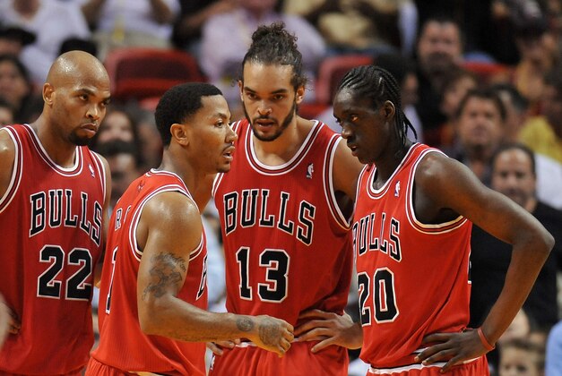 Oct 29, 2013; Miami, FL, USA; Chicago Bulls point guard Derrick Rose (center) talks with power forward Taj Gibson (second from left)  center Joakim Noah (13) and small forward Tony Snell (right) during a game against the Miami Heat at American Airlines Arena. Mandatory Credit: Steve Mitchell-USA TODAY Sports