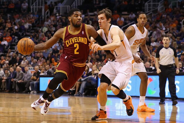 PHOENIX, AZ - MARCH 12:  Kyrie Irving #2 of the Cleveland Cavaliers drives the ball against Goran Dragic #1 of the Phoenix Suns during the first half of the NBA game at US Airways Center on March 12, 2014 in Phoenix, Arizona.  The Cavaliers defeated the Suns 110-101. NOTE TO USER: User expressly acknowledges and agrees that, by downloading and or using this photograph, User is consenting to the terms and conditions of the Getty Images License Agreement.  (Photo by Christian Petersen/Getty Images)