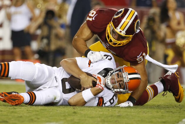 Cleveland Browns quarterback Brian Hoyer is sacked by Washington Redskins outside linebacker Ryan Kerrigan during the first half of an NFL preseason football game Monday, Aug. 18, 2014, in Landover, Md. (AP Photo/Evan Vucci)