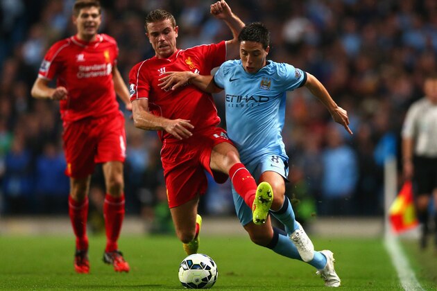 MANCHESTER, ENGLAND - AUGUST 25:  Jordan Henderson of Liverpool battles with Samir Nasri of Manchester City during the Barclays Premier League match between Manchester City and Liverpool at the Etihad Stadium on August 25, 2014 in Manchester, England.  (Photo by Clive Brunskill/Getty Images)