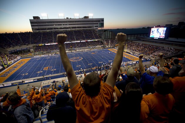 Fans cheer from the stands at Bronco Stadium during an NCAA college football game between Boise State and Nevada, Saturday, Oct. 19, 2013 in Boise, Idaho. (AP Photo/Ted S. Warren)
