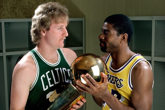 LOS ANGELES - 1986:  Larry Bird #33 of the Boston Celtics poses for a portrait with Magic Johnson of the Los Angeles Lakers with each holding the NBA Championship Trophy at The Great Western Forum in Los Angeles, California.   NOTE TO USER: User expressly acknowledges and agrees that, by downloading and/or using this Photograph, User is consenting to the terms and conditions of the Getty Images License Agreement. Mandatory copyright notice and Credit:  Copyright 2001 NBAE  (Photo by Andrew D. Bernstein/NBAE/Getty Images)