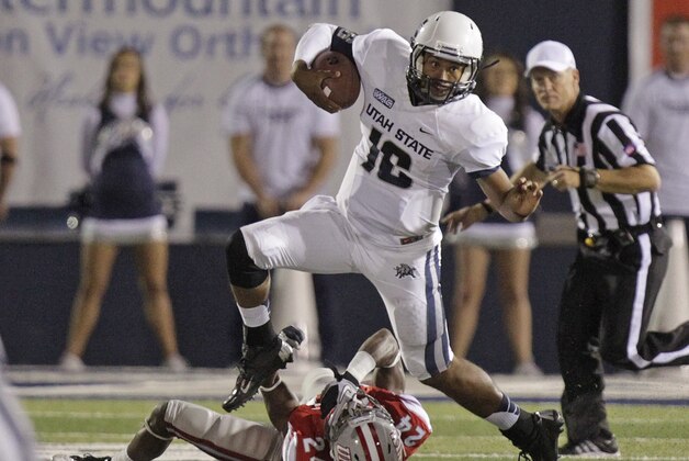 FILE - In this Sept. 29, 2012, file photo, Utah State quarterback Chuckie Keeton (16) hurdles UNLV defensive back Fred Wilson (24) in the fourth quarter of an NCAA college football game, in Logan, Utah. Nothing stung more in a disappointing 2012 season for the Utah Utes than losing to a rival they have dominated for decades. The Utes will have a chance to avenge the loss when they host Utah State in the season opener on Thursday night, Aug. 29, 2013. (AP Photo/Rick Bowmer, File)