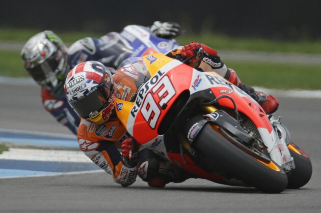 Marc Marquez, of Spain, leads Jorge Lorenzo, of Spain, on his way to winning the Indianapolis Moto GP motorcycle race at the Indianapolis Motor Speedway in Indianapolis, Sunday, Aug. 10, 2014.  (AP Photo/Michael Conroy)