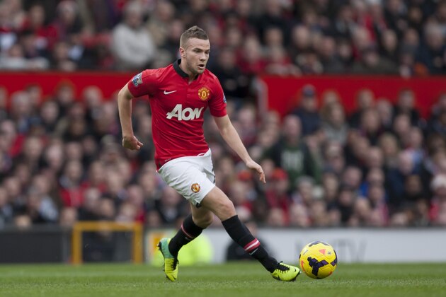 Manchester United's Tom Cleverley takes the ball downfield during his team's English Premier League soccer match against Newcastle at Old Trafford Stadium, Manchester, England, Wednesday Dec. 7, 2013. (AP Photo/Jon Super)
