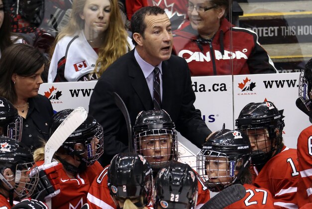 Dec 30, 2013; Toronto, Ontario, Canada; Canada head coach Kevin Dineen talks to the players during a break in the action against USA during the first period in an exhibition hockey game at Air Canada Centre. USA beat Canada 3-2. Mandatory Credit: Tom Szczerbowski-USA TODAY Sports