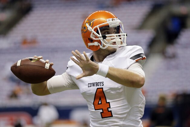 Oklahoma State's J.W. Walsh goes through drills prior to an NCAA college football game against Texas San Antonio, Saturday,  Sept. 7, 2013, in San Antonio. (AP Photo/Eric Gay)