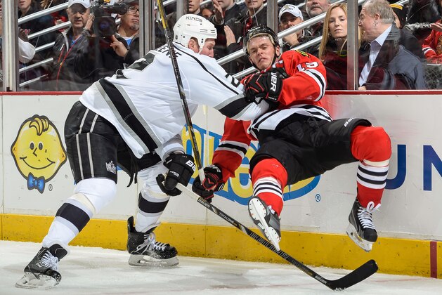 CHICAGO, IL - DECEMBER 30: Matt Greene #2 of the Los Angeles Kings levels Jonathan Toews #19 of the Chicago Blackhawks during the NHL game on December 30, 2013 at the United Center in Chicago, Illinois. (Photo by Bill Smith/NHLI via Getty Images)