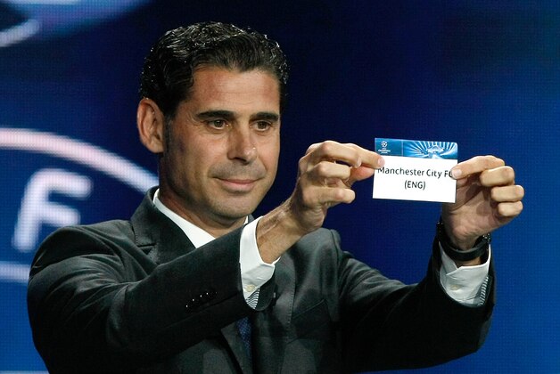 Former Real madrid captain Fernando Hierro, shows the name of Manchester City, who will play Group E,  during the UEFA Champions League draw at the Grimaldi Forum, in Monaco, Thursday, Aug. 28, 2014. (AP Photo/Claude Paris)