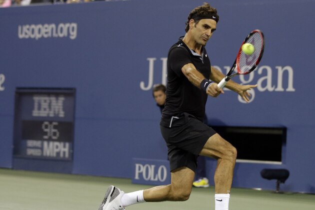 Roger Federer, of Switzerland, returns a shot to Marinko Matosevic, of Australia, during the first round of the 2014 U.S. Open tennis tournament Tuesday, Aug. 26, 2014, in New York. (AP Photo/Darron Cummings)