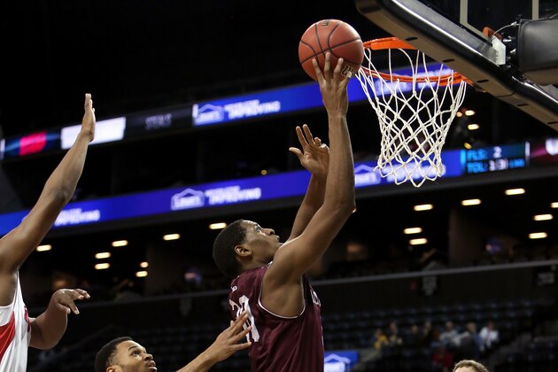 NEW YORK, NY - MARCH 13: Ryan Rhoomes #30 of the Fordham Rams drives to the basket against Vee Sanford #43 of the Dayton Flyers in the second half in the Second Round of the 2014 Atlantic 10 Men's Basketball Tournament at Barclays Center on March 13, 2014 in the Brooklyn Borough of New York City.  (Photo by Mike Lawrie/Getty Images)