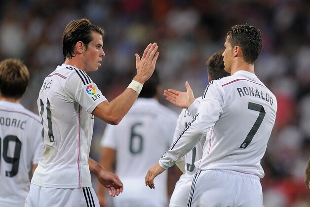 MADRID, SPAIN - AUGUST 25:  Cristiano Ronaldo of Real Madrid celebrates with Gareth Bale after scoring Real's 2nd goal during the La liga match between Real Madrid CF and Cordoba CF at Estadio Santiago Bernabeu on August 25, 2014 in Madrid, Spain.  (Photo by Denis Doyle/Getty Images)