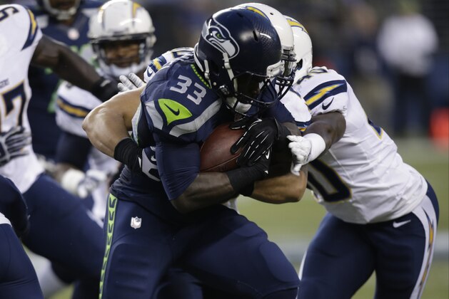 Seattle Seahawks Christine Michael carries the ball against the San Diego Chargers in the first half of a preseason NFL football game, Friday, Aug. 15, 2014, in Seattle. (AP Photo/Stephen Brashear)