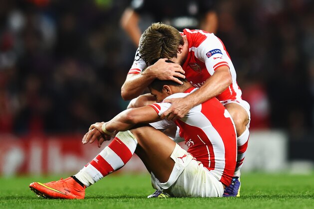 LONDON, ENGLAND - AUGUST 27:  Alexis Sanchez (L) of Arsenal celebrates with team mate Nacho Monreal of Arsenal at the end of the UEFA Champions League Qualifier 2nd leg match between Arsenal and Besiktas at the Emirates Stadium on August 27, 2014 in London, United Kingdom.  (Photo by Shaun Botterill/Getty Images)