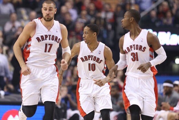 Feb 19, 2014; Toronto, Ontario, CAN; Toronto Raptors guard DeMar DeRozan (10) with center Jonas Valanciunas (17) and guard Terrence Ross (31) against the Chicago Bulls at Air Canada Centre. The Bulls beat the Raptors 94-92. Mandatory Credit: Tom Szczerbowski-USA TODAY Sports