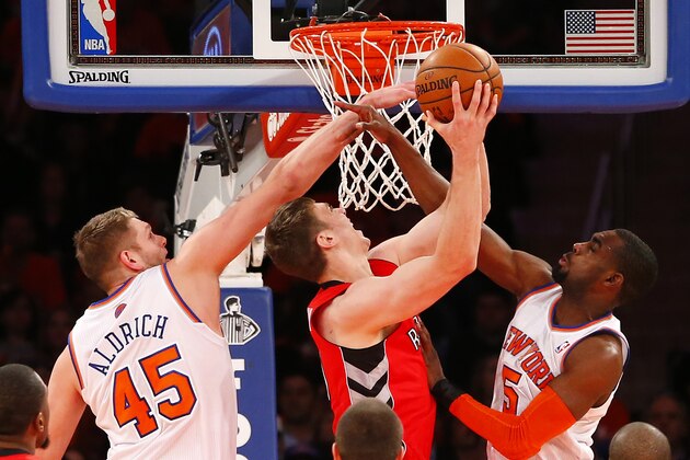 NEW YORK, NY - APRIL 16: Tyler Hansbrough #50 of the Toronto Raptors attempts a shot as Cole Aldrich #45 and Tim Hardaway Jr. #5 of the New York Knicks defend in the second half during an NBA basketball game at Madison Square Garden on April. 16, 2014 in New York City. The Knicks defeated the Raptors 95-92. NOTE TO USER: User expressly acknowledges and agrees that, by downloading and/or using this Photograph, user is consenting to the terms and conditions of the Getty Images License Agreement. (Photo by Rich Schultz /Getty Images)