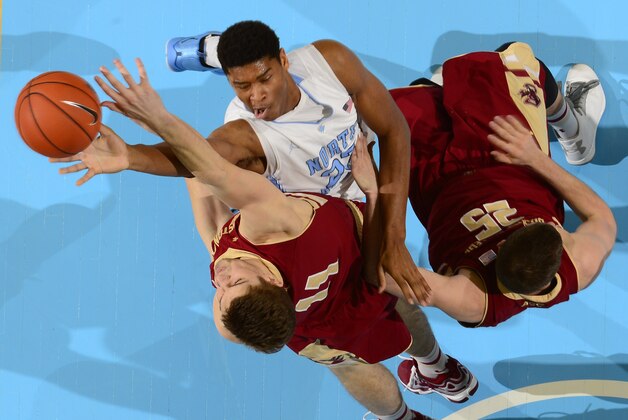 Jan 18, 2014; Chapel Hill, NC, USA;  North Carolina Tar Heels forward Isaiah Hicks (22) shoots as Boston College Eagles forward Will Magarity (11) and guard Joe Rahon (25) defend in the first half. The Tar Heels defeated the Eagles 82-71 at Dean E. Smith Student Activities Center. Mandatory Credit: Bob Donnan-USA TODAY Sports
