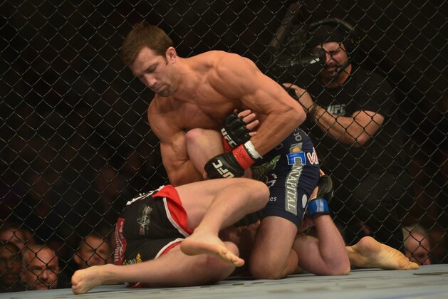 Apr 26, 2014; Baltimore, MD, USA;  Luke Rockhold (top) Tim Boetschat grapple during the first round at Baltimore Arena. Rockhold defeated Boetsch by submission in the first round Mandatory Credit: Tommy Gilligan-USA TODAY Sports