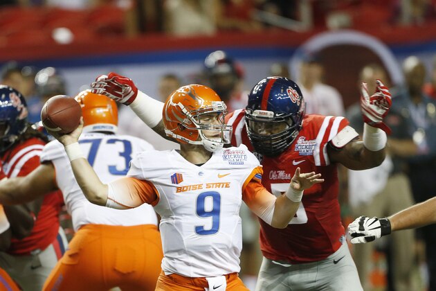 Boise State quarterback Grant Hedrick (9) throws under pressure from Mississippi defensive tackle Robert Nkemdiche (5)) in the first half of an NCAA college football game, Thursday, Aug. 28, 2014, in Atlanta.  (AP Photo/John Bazemore)