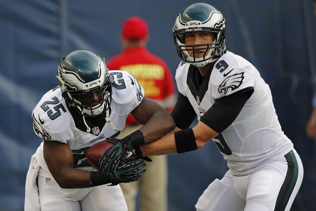 Philadelphia Eagles quarterback Nick Foles (9) hands off to running back LeSean McCoy as Eagles warm up for an NFL preseason football game against the Chicago Bears on Friday, Aug. 8, 2014, in Chicago. (AP Photo/Charles Rex Arbogast)