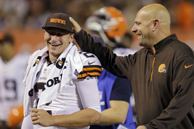 Cleveland Browns head coach Mike Pettine, right, pats quarterback Johnny Manziel on the head as they leave the field at halftime of a preseason NFL football game against the Chicago Bears, Thursday, Aug. 28, 2014, in Cleveland. (AP Photo/Tony Dejak)