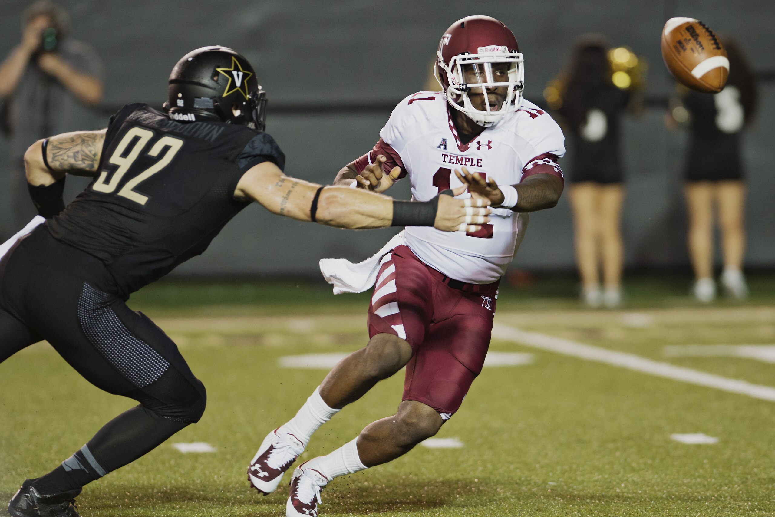 Temple quarterback P.J. Walker (11) tosses the ball before getting hit by Vanderbilt's Kyle Woestmann (92) in the first quarter of an NCAA college football game Thursday, Aug. 28, 2014, in Nashville, Tenn. (AP Photo/Brian Powers)