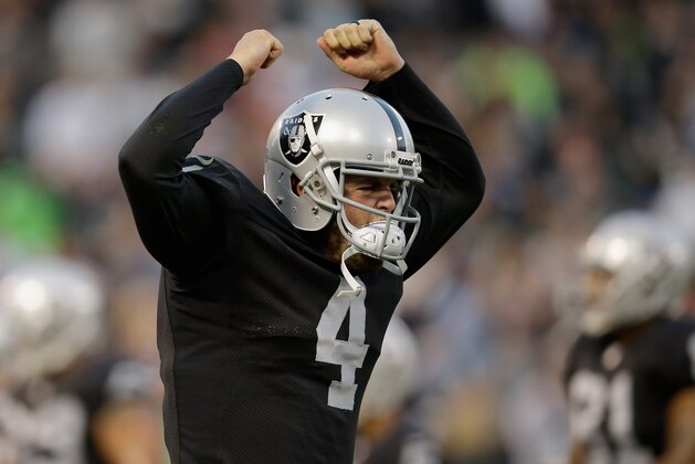 OAKLAND, CA - AUGUST 28: Quarterback Derek Carr #4 of the Oakland Raiders celebrates after a touchdown against the Seattle Seahawks during a preseason game at O.co Coliseum on August 28, 2014 in Oakland, California.  (Photo by Ezra Shaw/Getty Images)