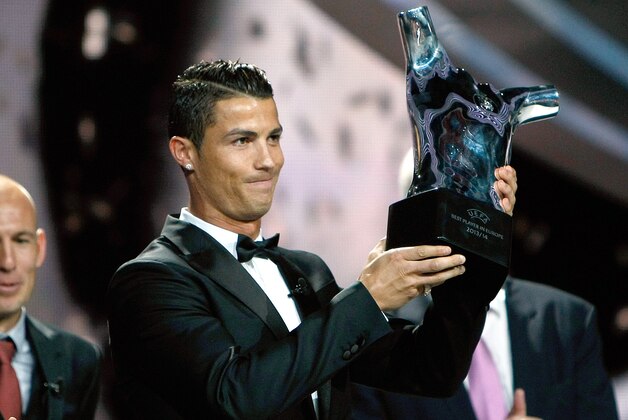 Named the best player of the year, Real Madrid Portuguese forward Cristiano Ronaldo, holds his trophy during the UEFA Champions League draw, at the Grimaldi Forum, in Monaco, Thursday, Aug. 28, 2014. (AP Photo/Claude Paris) Named the best player of the year, Real Madrid Portuguese forward Cristiano Ronaldo, holds his trophy during the UEFA Champions League draw, at the Grimaldi Forum, in Monaco, Thursday, Aug. 28, 2014. (AP Photo/Claude Paris)